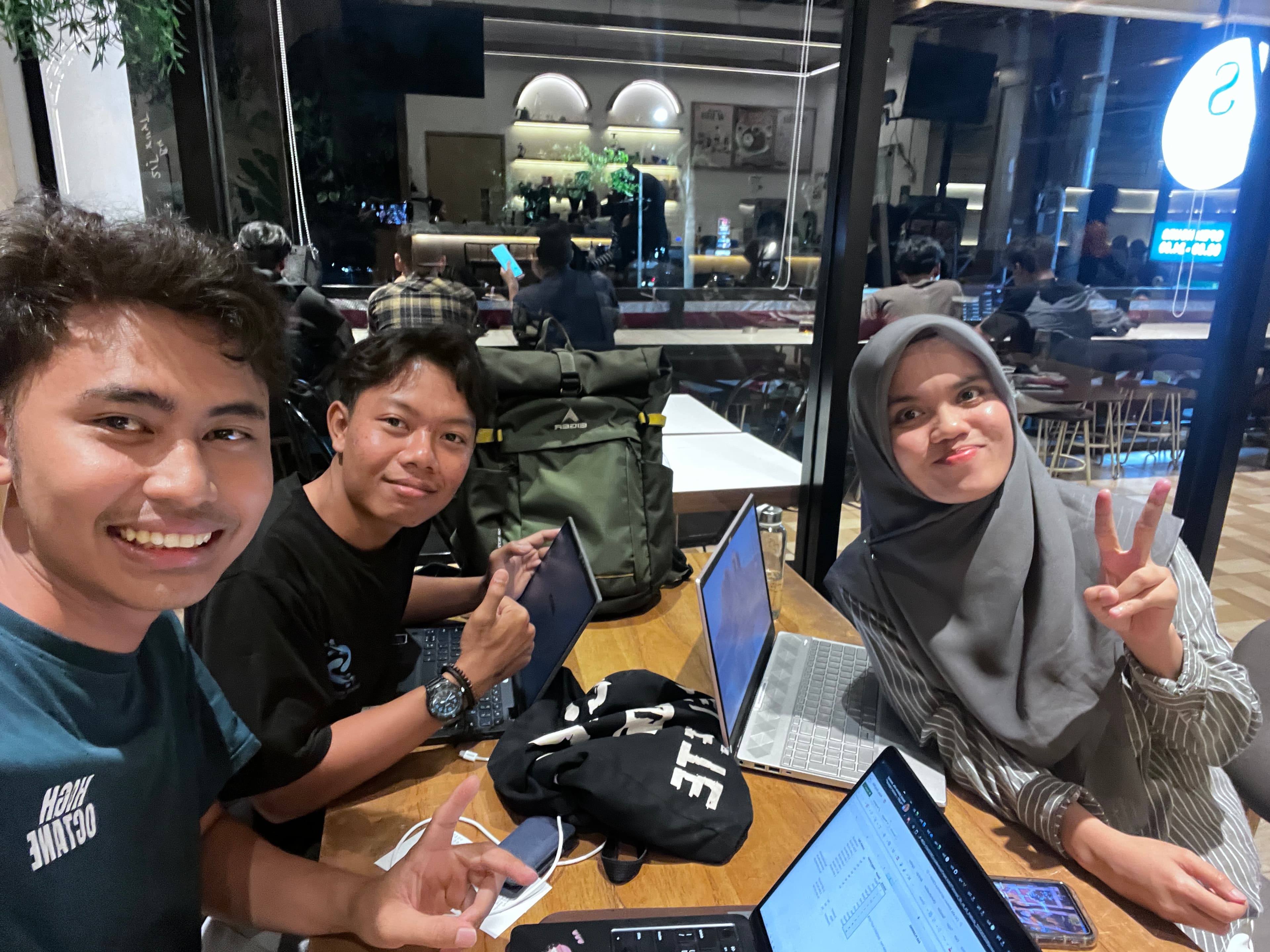 Robby, Mas Jihan, and Faiz catching up at a cafe