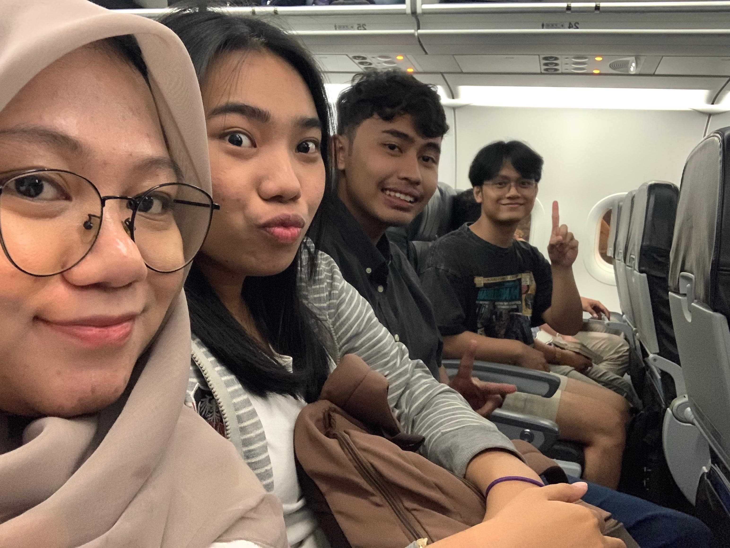 Farah, Shinta, Robby, and Adrian on a flight for the ISPO Rakyat research trip